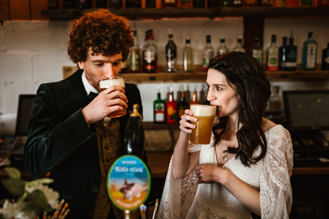 Bride and groom drinking beer at wellbeing farm