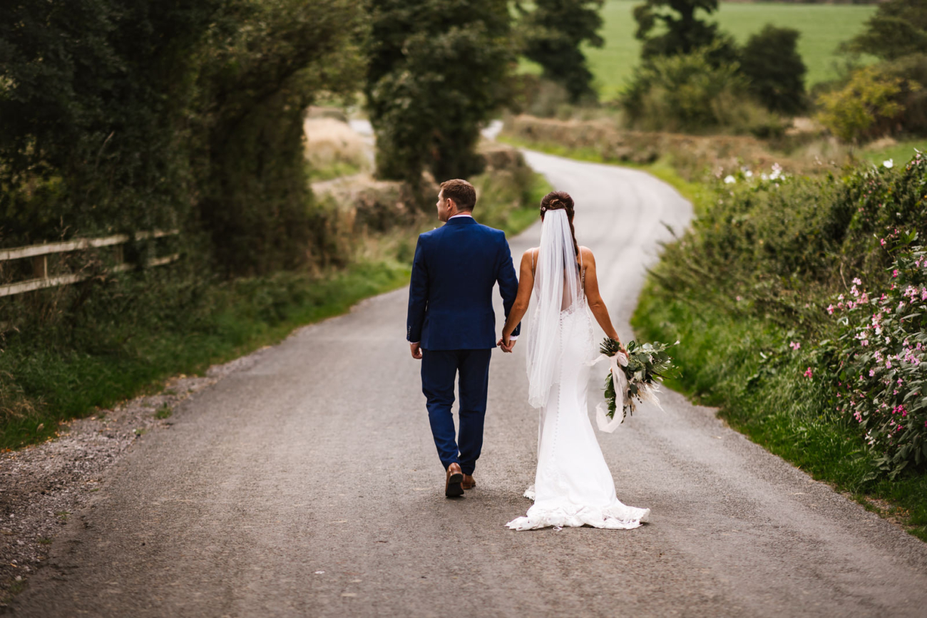 Bride and groom walking at bashall barn