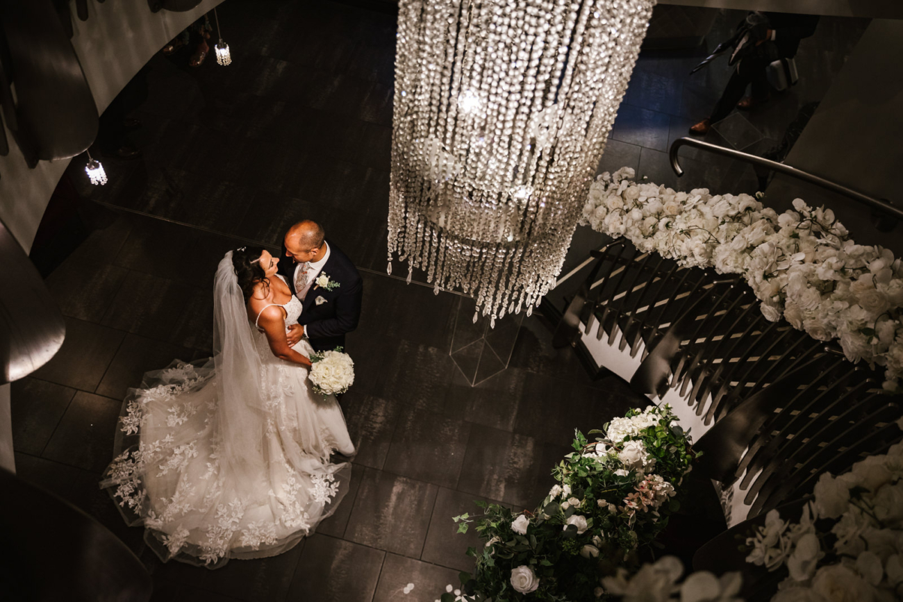 Couple under the chandelier at Stanley House