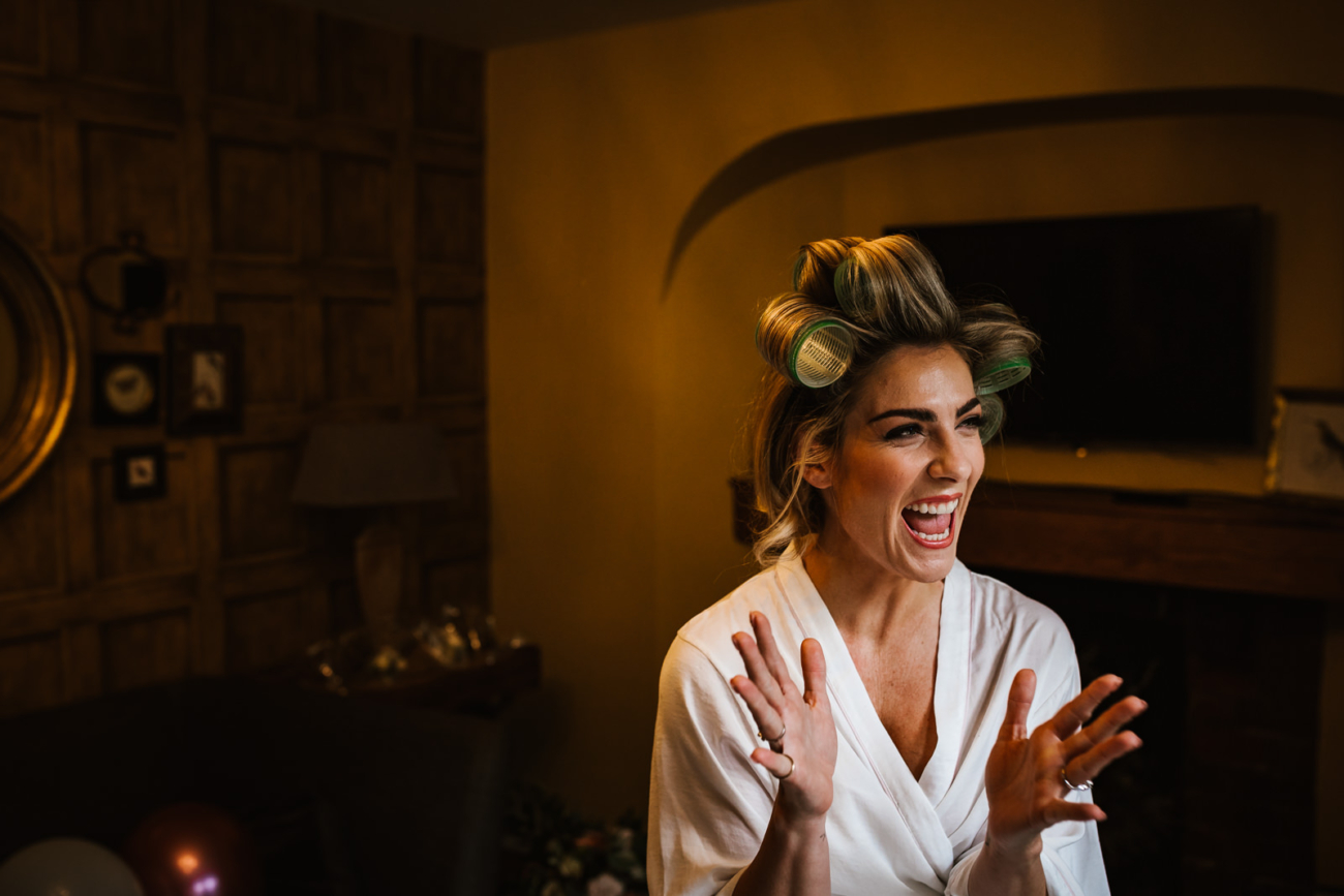 Bride laughing during prep