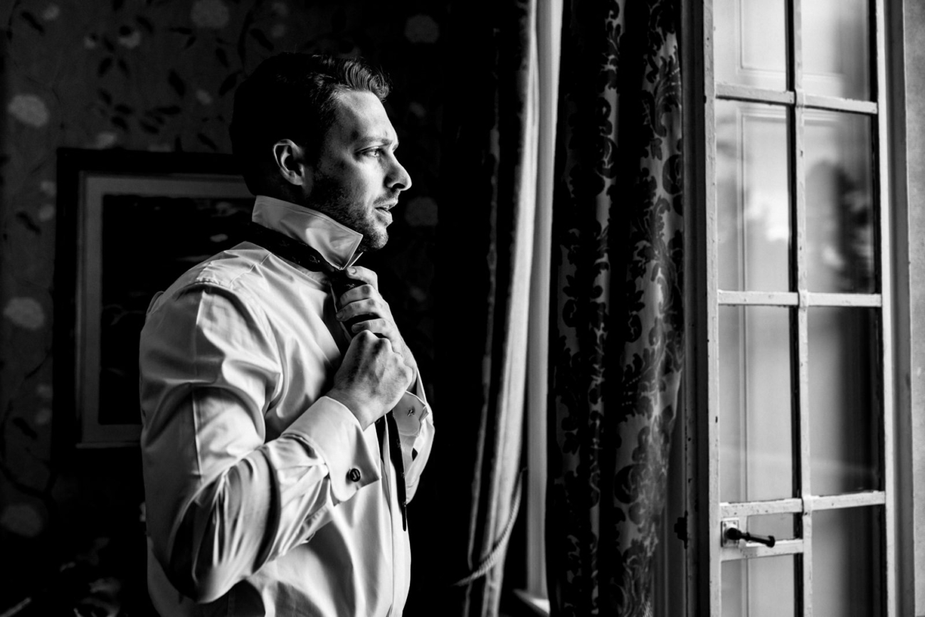 Groom getting ready at eaves hall