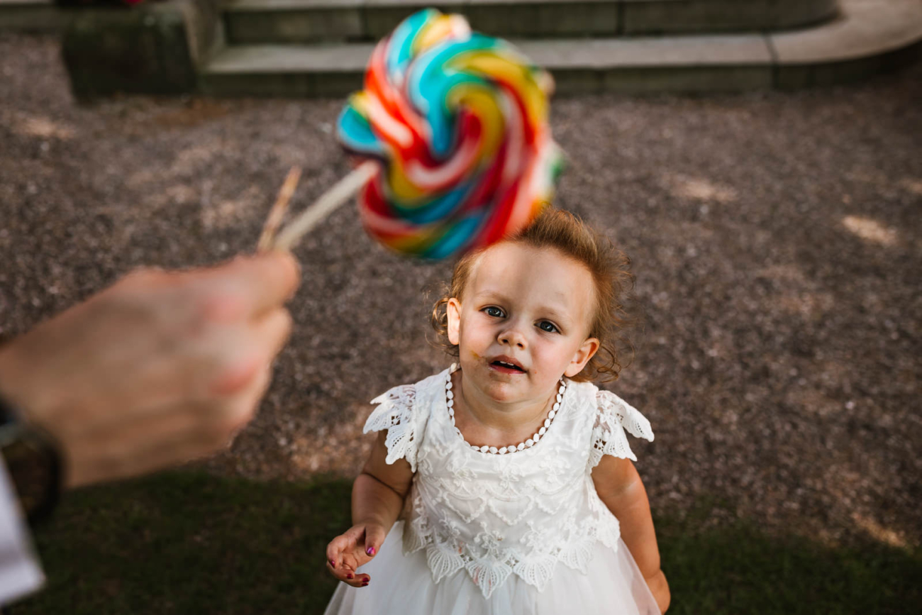 little girl looking at lolly